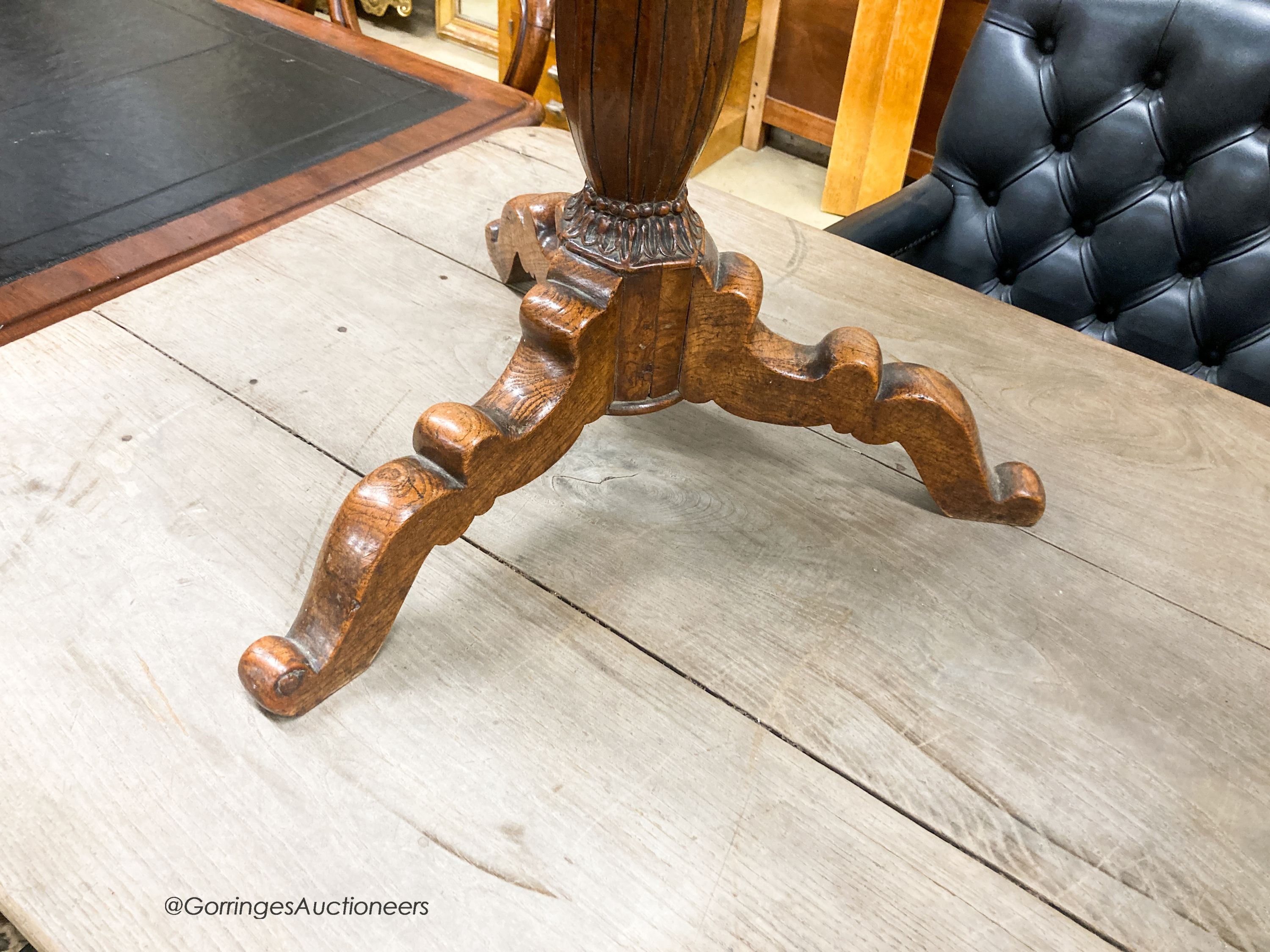 An early 20th century circular oak tripod table, W.67cm H.69cm